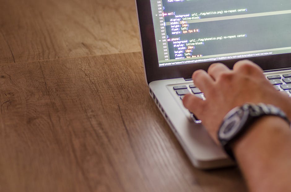 A computer screen displaying lines of colorful code in an integrated development environment, with syntax highlighting in shades of blue, pink, green, and yellow against a dark background. The code ap